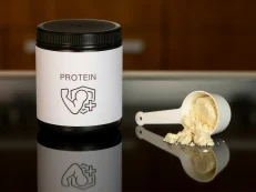 aleksander-saks-4CzpHxVzTFA-unsplash Container of protein powder with a scoop, illustrating high-protein nutrition for maintaining and building muscle, as advised by a CORU registered Galway dietitian.